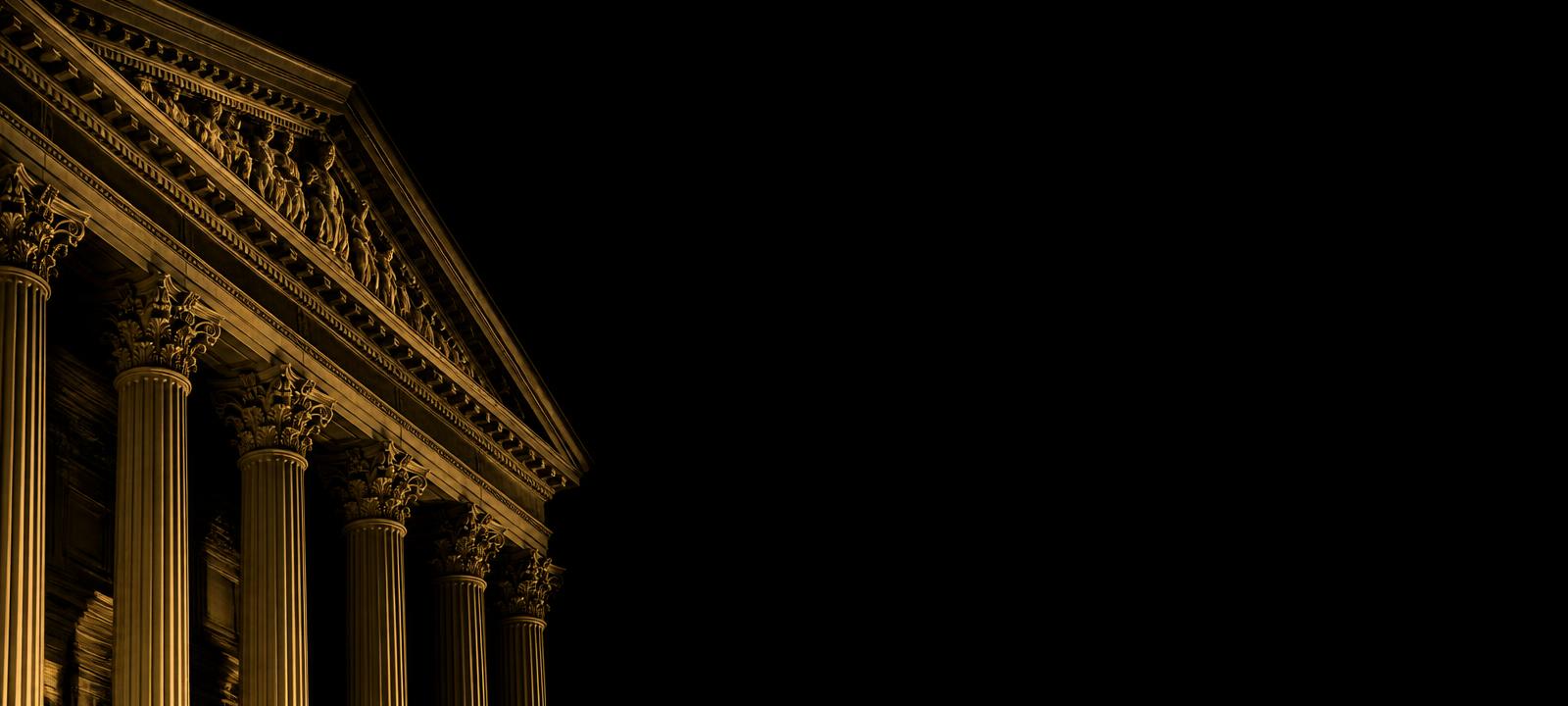 Fachada de tribunal iluminada em dourado